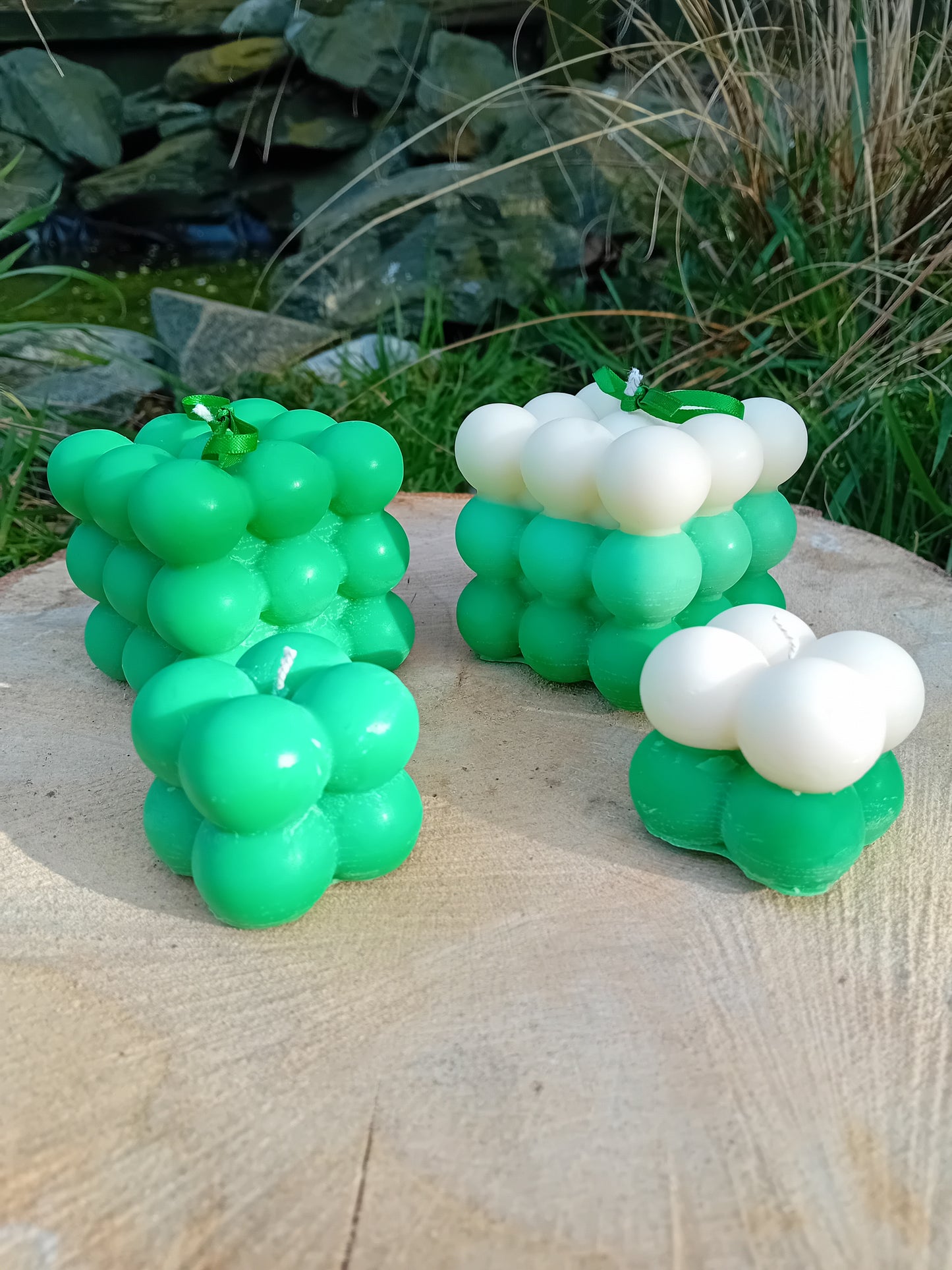 Plain green and ombre white/green fragranced Bubble candles - two of them are large, two are mini.