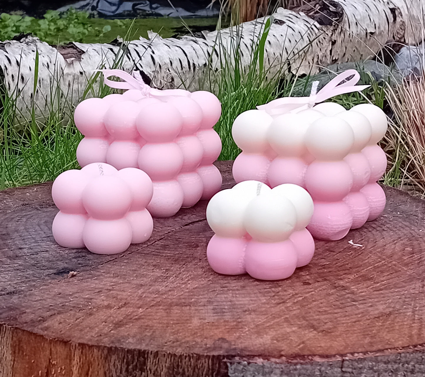 Plain pink and ombre white/pink fragranced Bubble candles - two of them are large, two are mini.