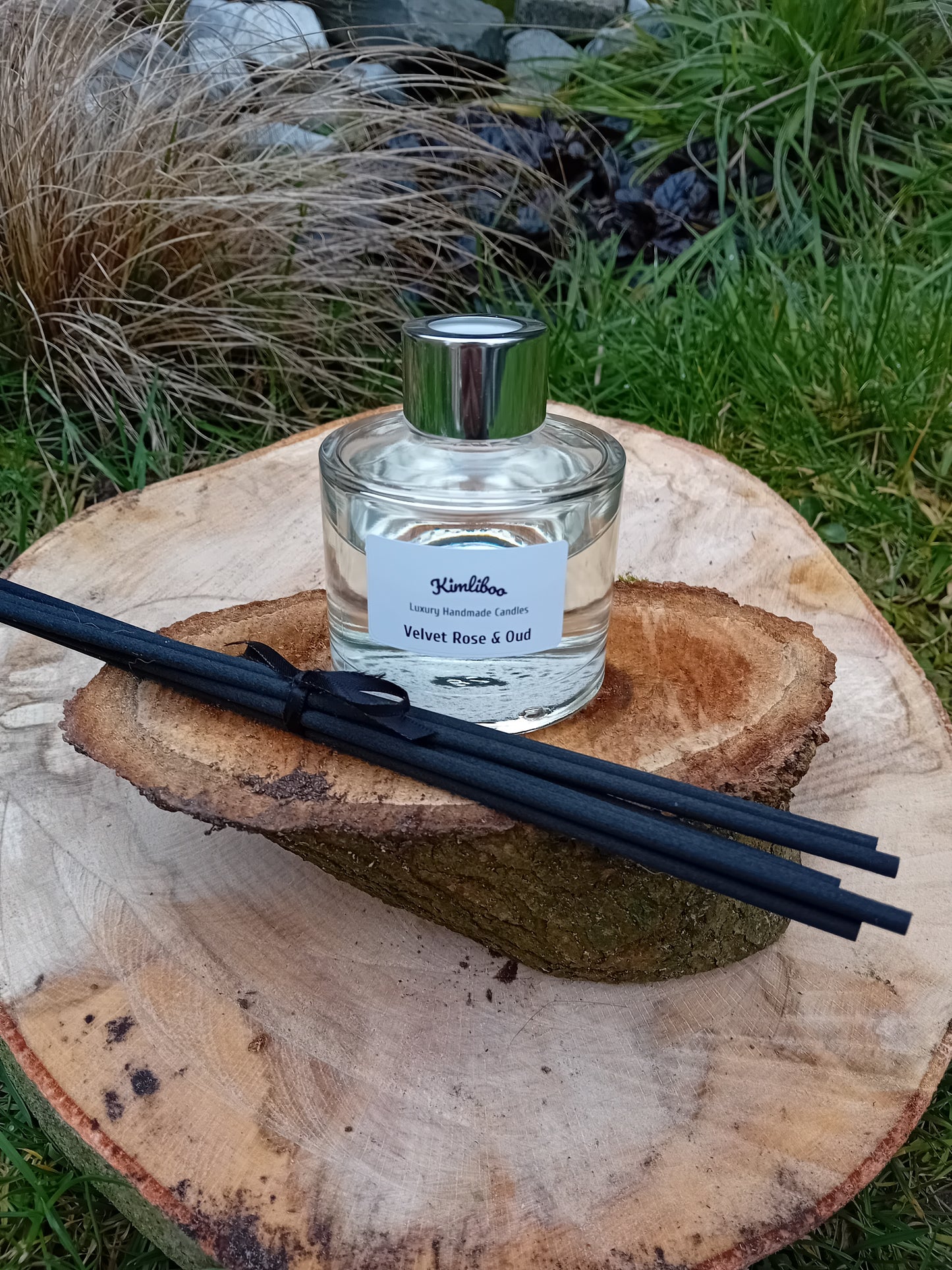 Velvet Rose & Oud fragranced reed diffuser with a 100ml clear glass jar and a bundle of black fibre reeds.